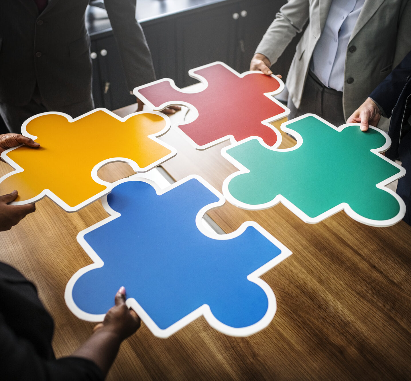 Business People Connecting Puzzle Pieces